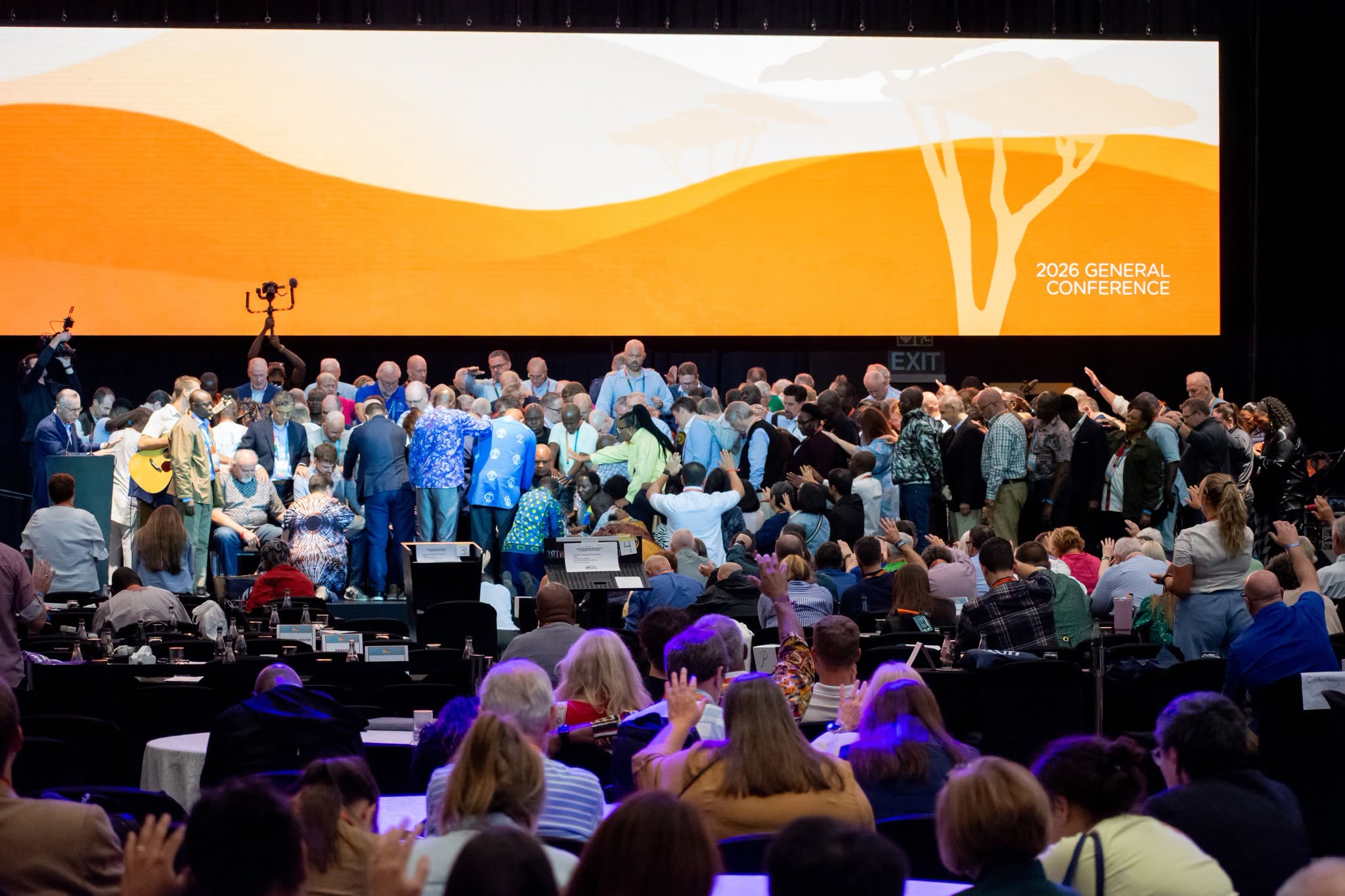 lay and clergy delegates pray over retiring Global Methodist Bishops