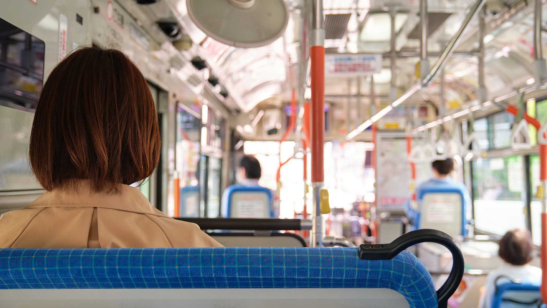 Woman riding on a bus.
